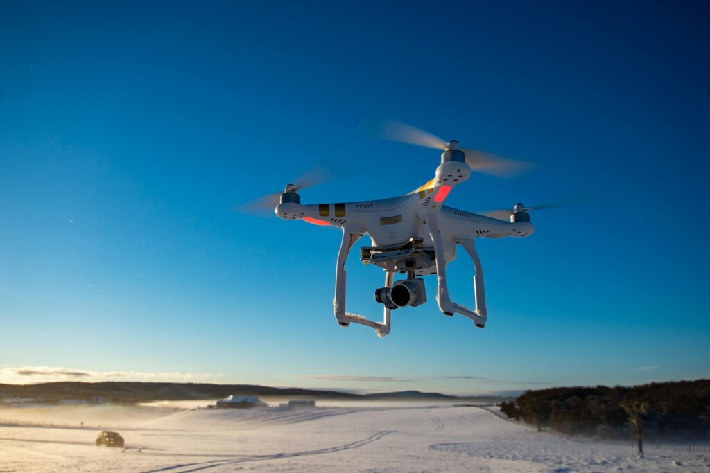 Aerial shot of a drone flying above a snow-covered field during winter in Tierra del Fuego.